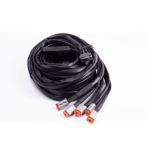 Baja Designs LP6, LP4 Wiring Harness, whole product on a studio background: A coiled wiring harness with five gray Deutsch connectors and a switch on white