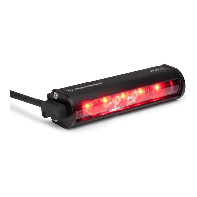 Baja Designs RTL-M Mini LED Rear Light Bar, whole product on a studio background: compact black RTL-M mini LED rear light bar glowing red with its cable on a white background