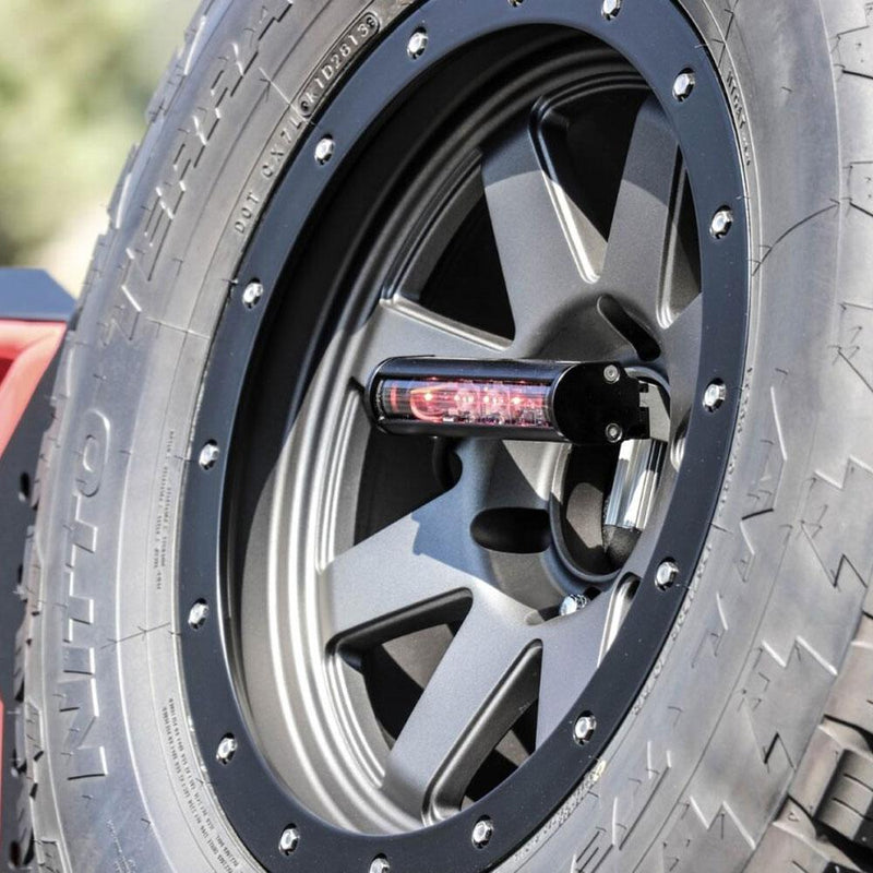 Baja Designs RTL-M Mini LED Rear Light Bar on a vehicle: RTL-M mini rear light bar mounted at the center of a spare wheel on an off-road tire