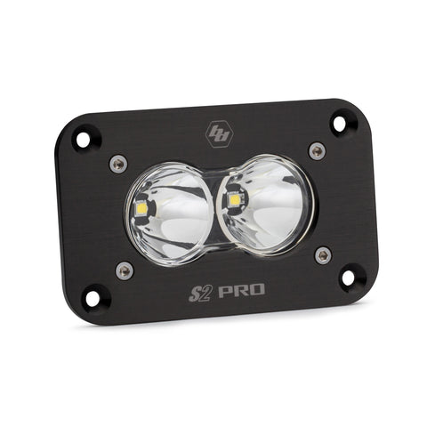 Baja Designs S2 Pro Black Flush Mount LED Auxiliary Light Pod, whole product on a studio background: A black S2 Pro flush mount LED pod with a clear spot lens and a flat mounting flange