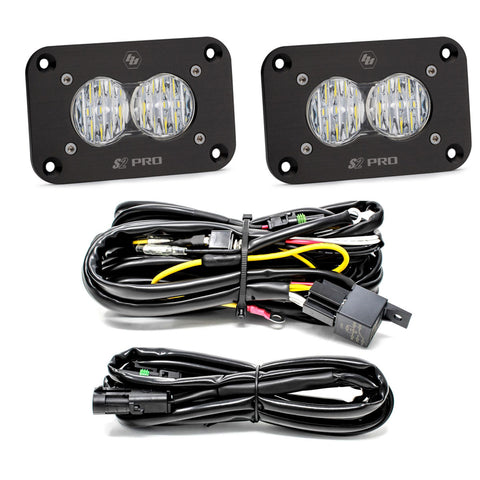Baja Designs S2 Pro Black Flush Mount LED Light Pod Reverse Kit, complete kit on a studio background: two black S2 Pro flush mount LED pods with clear fluted lenses, a relay wiring harness and an extension harness on a white background