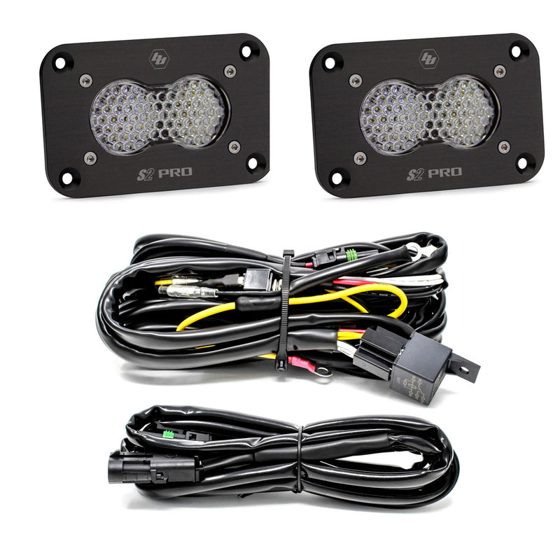 Baja Designs S2 Pro Black Flush Mount LED Light Pod Reverse Kit, complete kit on a studio background: two black S2 Pro flush mount LED pods with clear honeycomb lenses, a relay wiring harness and an extension harness on a white background