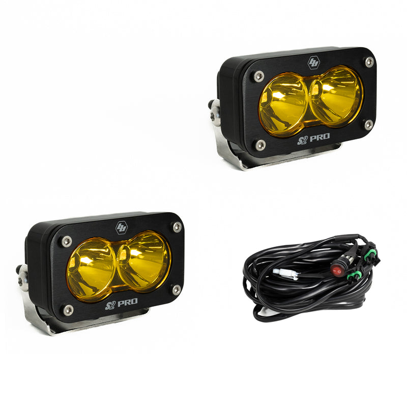 Baja Designs S2 Pro Black LED Auxiliary Light Pod Pair, whole product on a studio background: two black S2 Pro LED pods with amber smooth spot reflector lenses and a wiring harness with switch on a white background