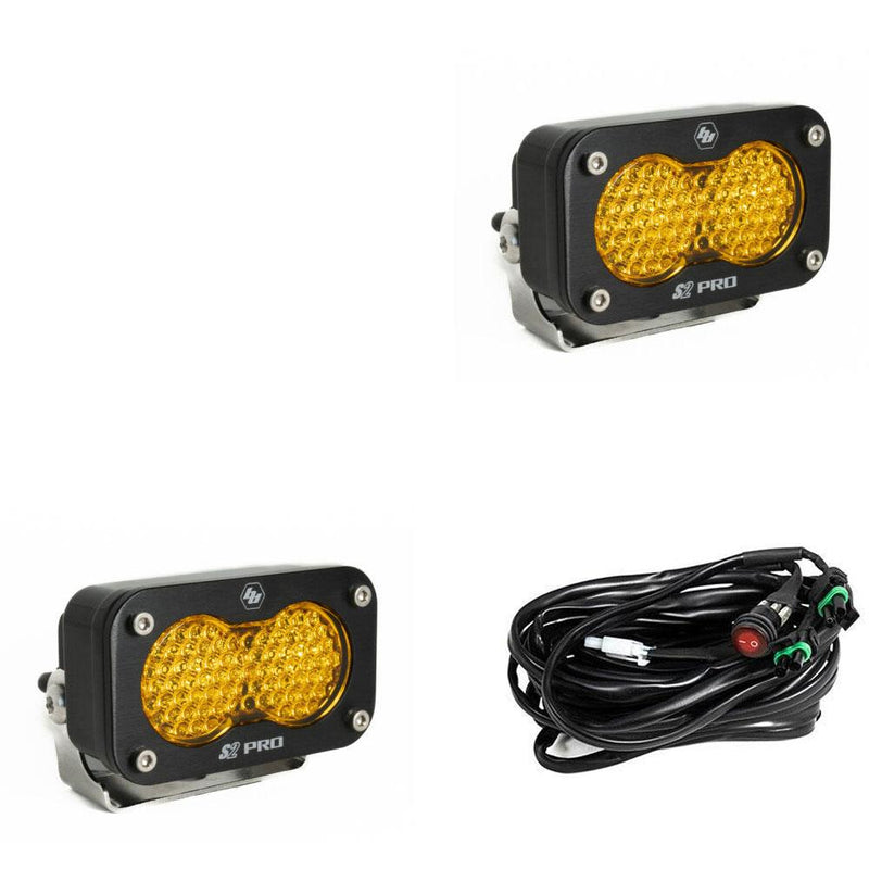 Baja Designs S2 Pro Black LED Auxiliary Light Pod Pair, whole product on a studio background: two black S2 Pro LED pods with amber dimpled work scene style lenses and a wiring harness with switch on a white background