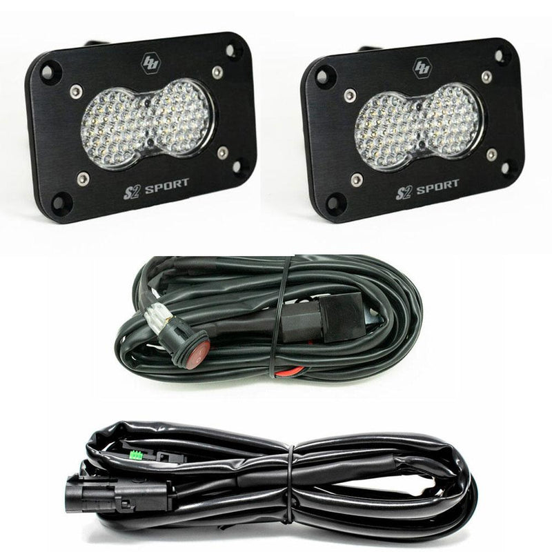 Baja Designs S2 Sport Black Flush Mount LED Light Pod Reverse Kit, complete kit on a studio background: two black flush mount S2 Sport pods with clear dimpled lenses plus a switch harness and an extension harness on a white background