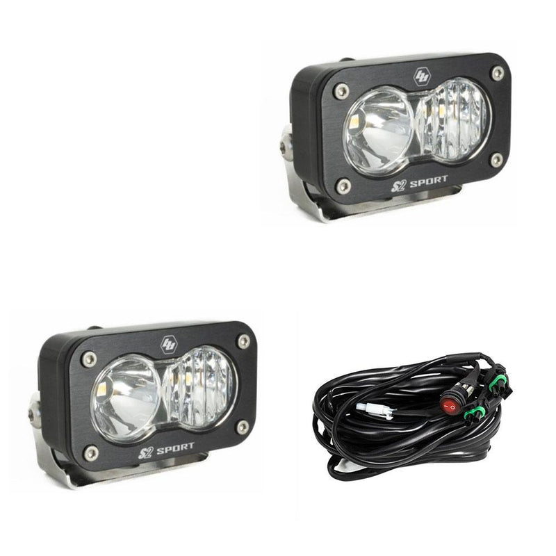 Baja Designs S2 Sport Black LED Auxiliary Light Pod Pair, whole product on a studio background: pair of black S2 Sport light pods with clear driving combo lenses and a wiring harness on a white background