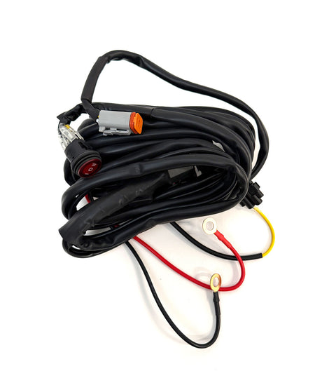 Baja Designs Squadron 2.0 4-pin Deutsch On/Off 1-Light (150W max) with Backlight Harness, whole product on a studio background: A coiled single light harness with a Deutsch connector, switch and red and black power leads on white