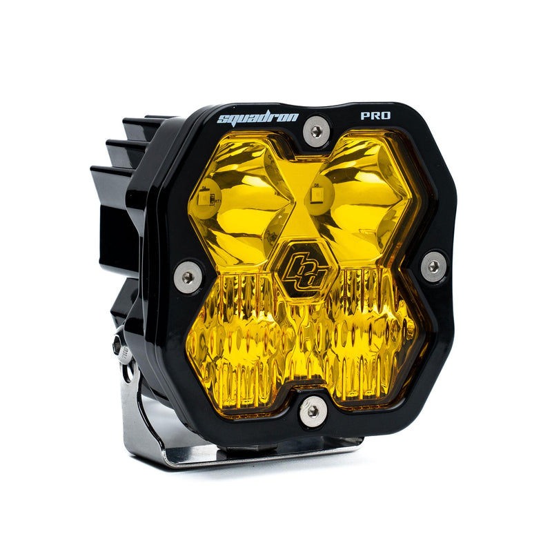 Baja Designs Squadron 2.0 Pro Black LED Auxiliary Light Pod, whole product on a studio background: A black Baja Designs Squadron Pro LED pod with an amber driving/combo lens on a white background