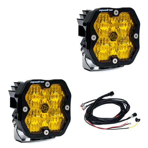 Baja Designs Squadron 2.0 Sport Black LED Auxiliary Light Pod Pair, whole product on a studio background: pair of black Squadron Sport pods with amber driving combo lenses, with wiring harness, on white