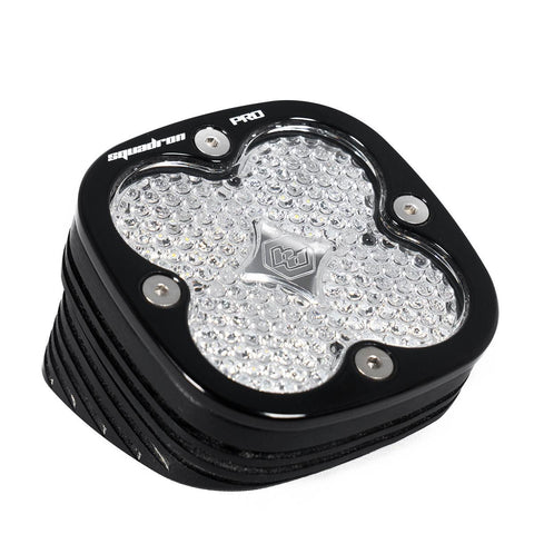 Baja Designs Squadron Pro Black Angle Mount LED Auxiliary Light Pod, whole product on a studio background: A black Squadron Pro LED pod with a clear textured lens on a white background