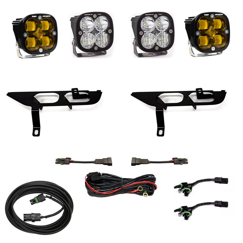Baja Designs Squadron SAE/Pro Fog Pocket Light Kit, complete kit on a studio background: four black Squadron pods, two amber and two clear, two black fog pocket brackets, a red relay harness, adapter harnesses and coiled cables on white; sibling