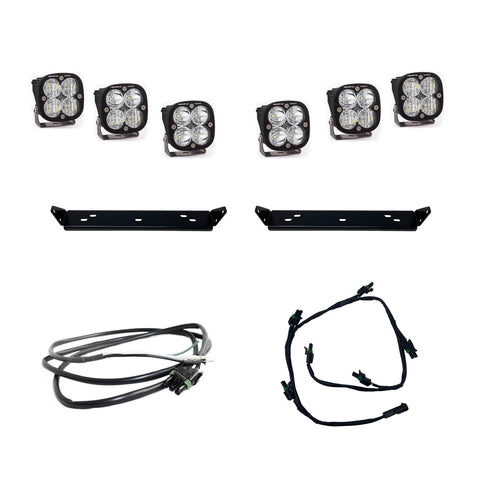 Baja Designs Squadron Sport Behind Grille Light Kit, complete kit on a studio background: six square Squadron LED pods with clear lenses, two black mounting plates and two wiring harnesses on white