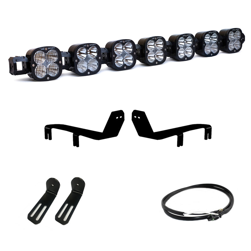Baja Designs XL Linkable Bumper Light Kit, complete kit on a studio background: A seven-pod XL Linkable light bar kit on white with two bumper brackets, two slotted mounts and a short coiled pigtail harness