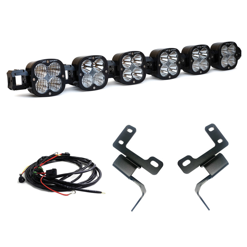 Baja Designs XL Linkable Bumper Light Kit, complete kit on a studio background: six XL Pro pods joined as one linkable bar with two bent black brackets and a wiring harness on white