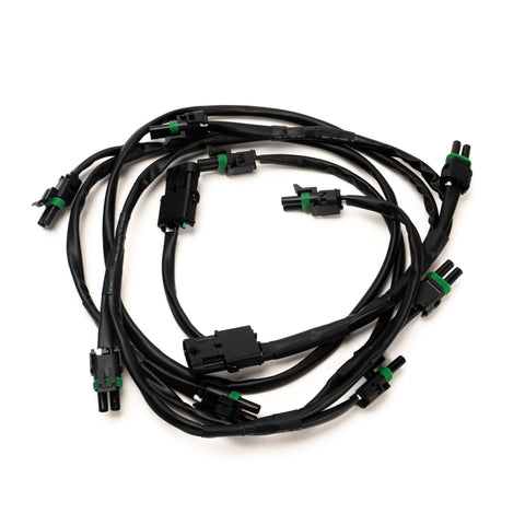 Baja Designs XL Linkable Wiring Harness, whole product on a studio background: A black linkable wiring harness with a main connector and several weatherproof light pigtails on a white background