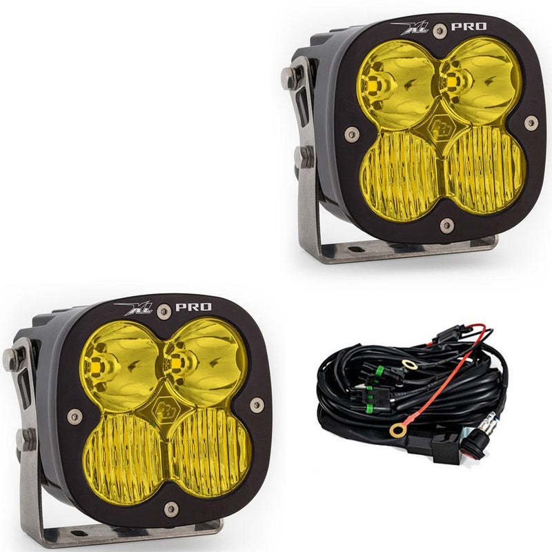 Baja Designs XL Pro LED Auxiliary Light Pod Pair, whole product on a studio background: A pair of black XL Pro LED light pods with amber driving/combo lenses on stainless brackets, shown with the wiring harness on a white background