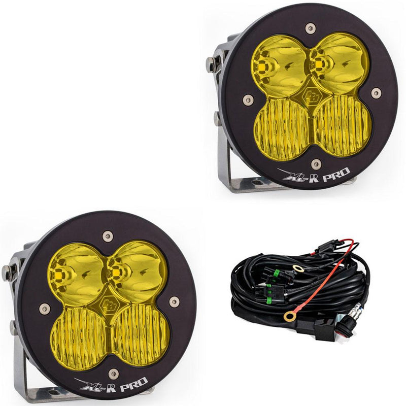 Baja Designs XL-R Pro LED Auxiliary Light Pod Pair, whole product on a studio background: A pair of black XL-R Pro LED light pods with amber driving/combo lenses on stainless brackets, shown with the wiring harness on a white background