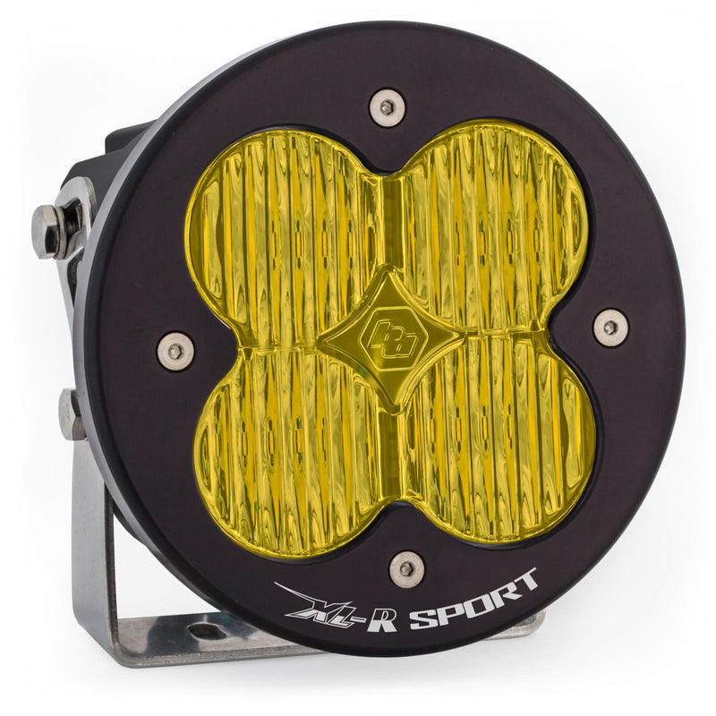 Baja Designs XL-R Sport LED Auxiliary Light Pod, whole product on a studio background: A single black XL-R Pro LED light pod with a amber wide cornering lens on a stainless mounting bracket, on a white background