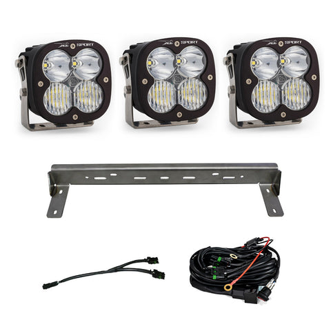Baja Designs XL Sport Bumper Kit, complete kit on a studio background: three XL Sport LED pods with clear lenses, a steel bumper mounting bar and wiring harnesses on a white background