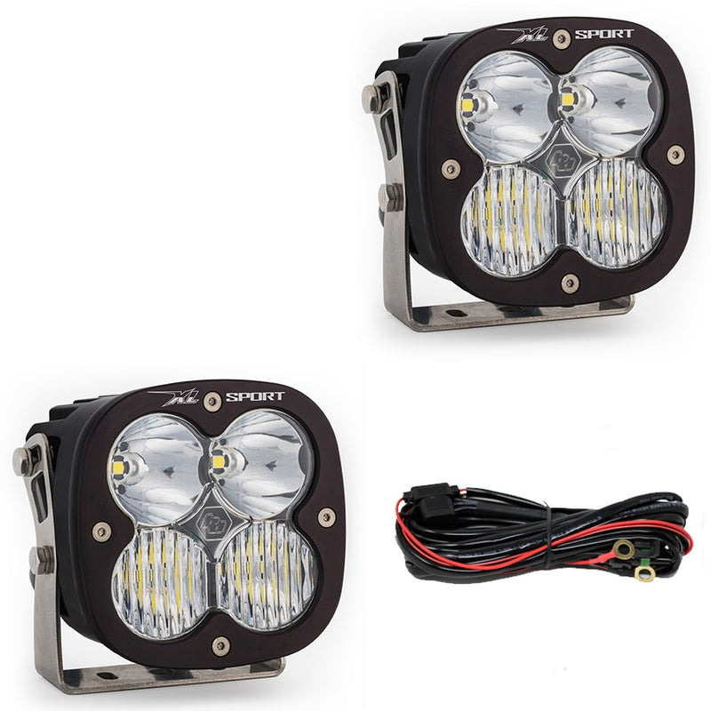 Baja Designs XL Sport Bumper Light Kit, complete kit on a studio background: two black XL Sport pods with clear lenses and a relay wiring harness on white
