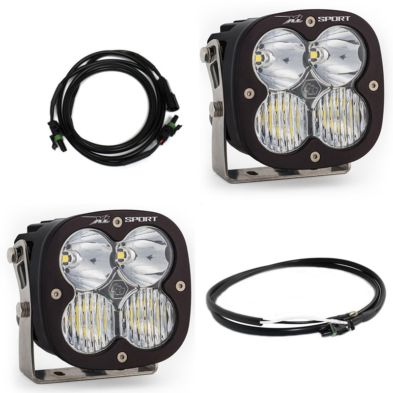 Baja Designs XL Sport Bumper Light Kit, complete kit on a studio background: two black XL Sport pods with clear lenses, a wiring harness and an extension cable on white