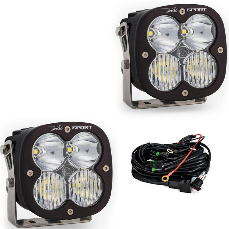 Baja Designs XL Sport LED Auxiliary Light Pod Pair, whole product on a studio background: A pair of black square Baja Designs XL Sport LED light pods with clear driving/combo lenses and a wiring harness, shown on white