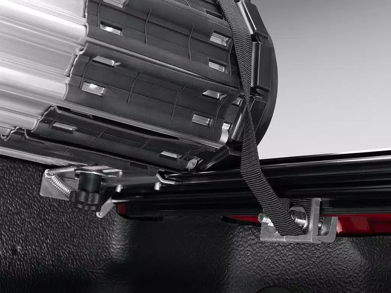 Underside of the rolled Revolver X2 cover showing the retaining strap and rail clamp