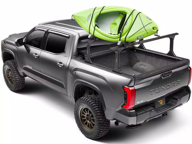 Grey pickup carrying a kayak on an optional bed rack mounted to the Revolver X4ts rails (rack sold separately)