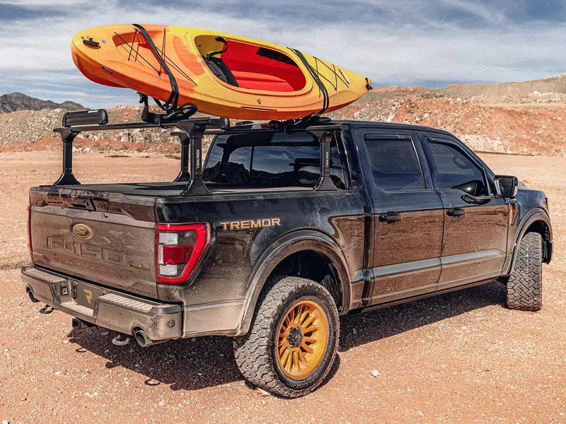 Pickup in the desert hauling a kayak on an optional rack over the Revolver X4ts cover (rack sold separately)