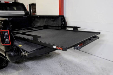 BEDSLIDE 1000 Classic cargo slide in Black Edition finish extended out over the open tailgate of a black pickup