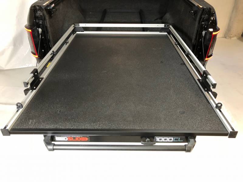 BEDSLIDE 1000 Classic cargo slide in Silver finish shown from above in a pickup bed with the 1000CL badge visible
