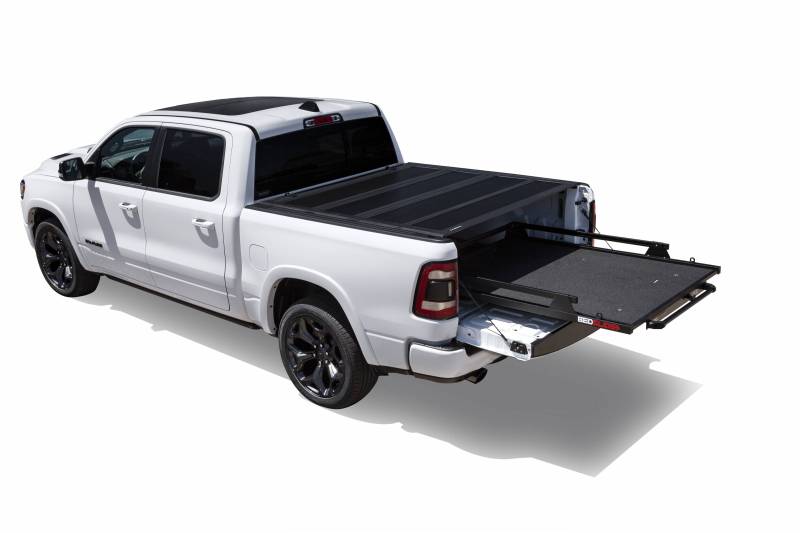 White Ram 1500 with a BEDSLIDE MAX Extension cargo slide in Black Edition finish extended fully clear of the tailgate