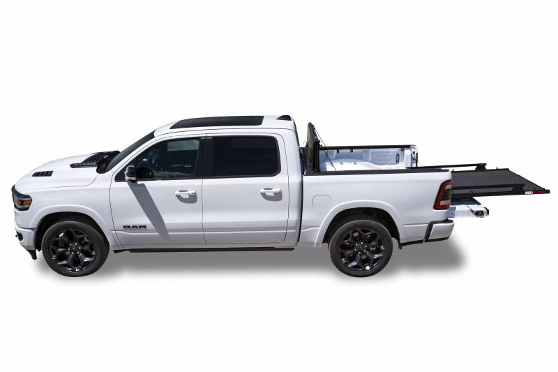 Side profile of a white Ram 1500 with a BEDSLIDE MAX Extension cargo slide in Black Edition finish fully extended