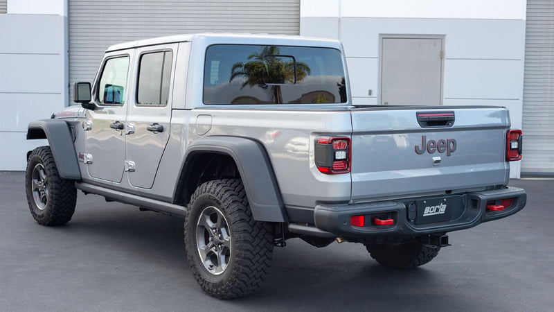 Borla ATAK Cat-Back Exhaust System installed on a Jeep Gladiator: A gray Jeep Gladiator seen from the rear quarter with a Borla plate on the bumper
