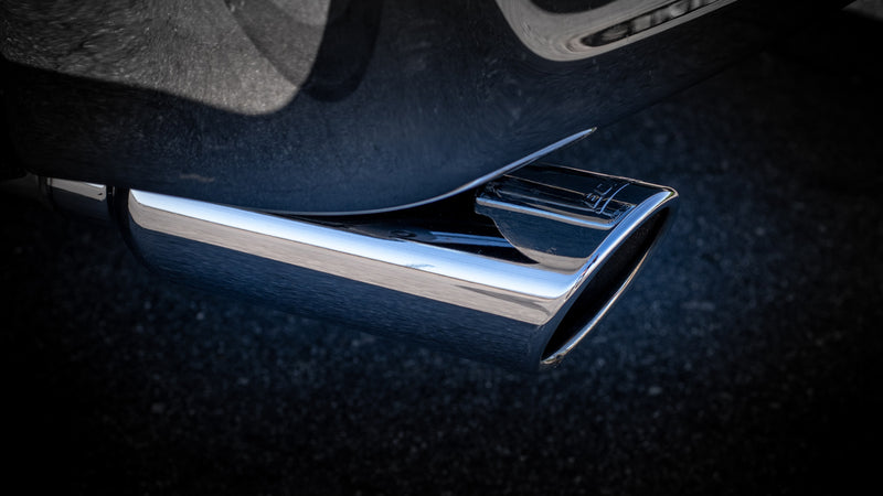 Borla Touring Cat-Back Exhaust System on a vehicle: close-up of a polished angle-cut exhaust tip beneath a dark vehicle body