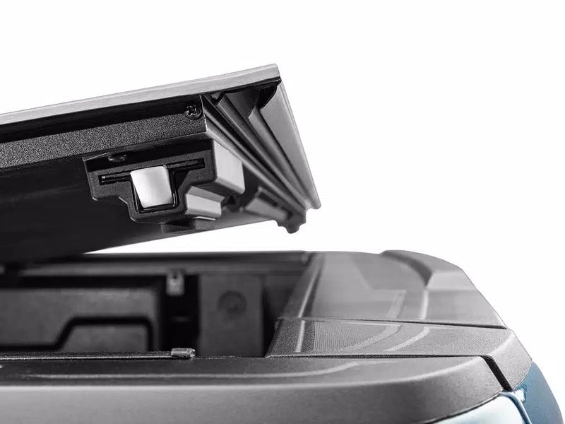 Close-up of the Select cover's raised rear panel from below, showing the drop-and-go latch block.
