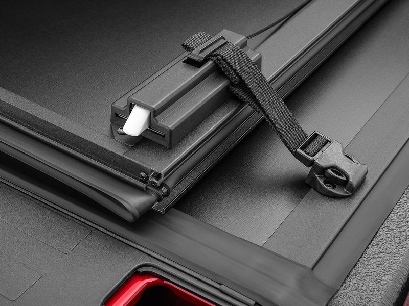 Close-up of the Select pull strap and buckle across the folded panel stack and side rail.