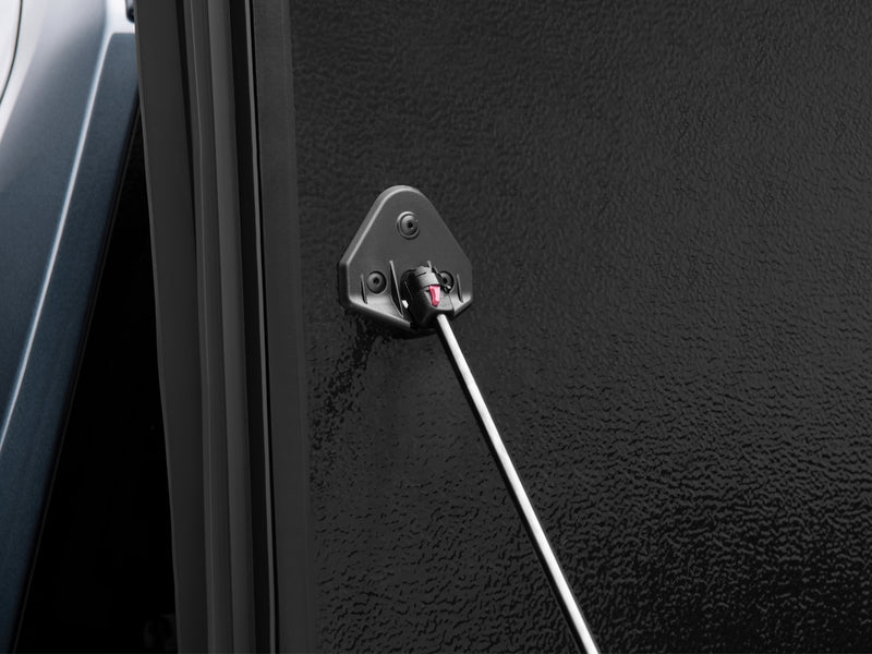 Close-up of the Flex prop-rod pivot bracket on the cover's textured inner panel face with the rod extended.