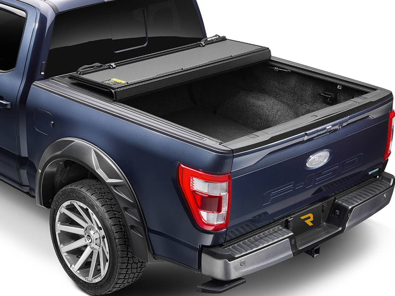 Hard folding tonneau cover folded two-thirds toward the cab, showing the open bed