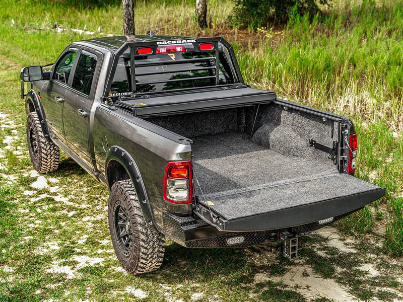 Hard tonneau cover folded at the cab with the tailgate down and bed open