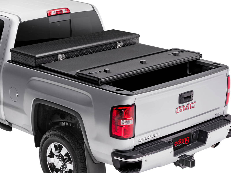Hard folding tonneau cover with the rear panel folded forward behind a separate crossover toolbox