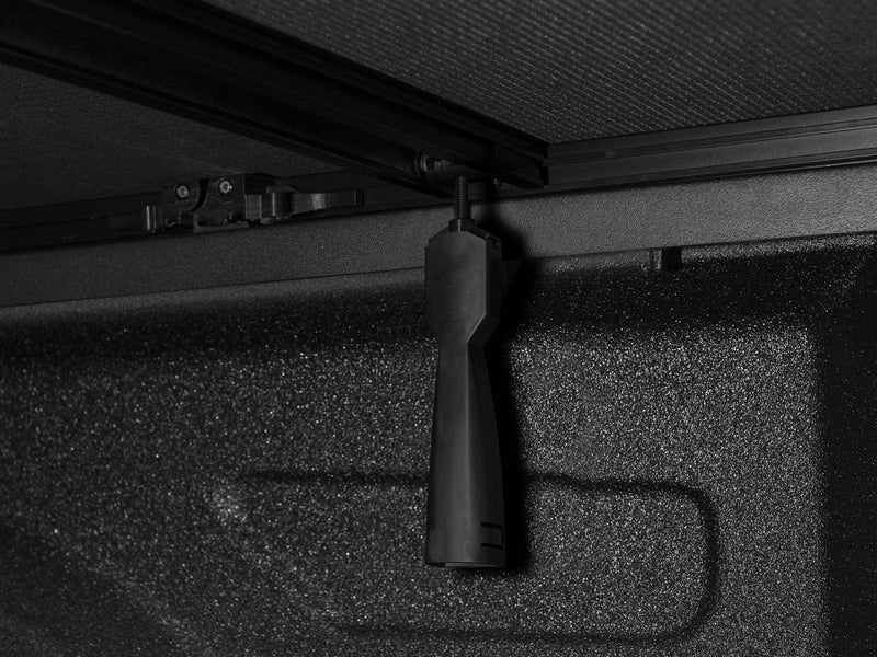 Clamp handle hanging below the side rail inside the bed