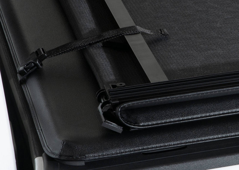 Storage strap holding the folded soft cover sections together