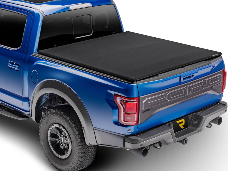 Black canvas soft tri-fold tonneau cover closed flat over a pickup bed