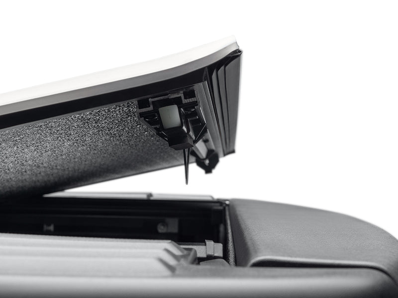 Close-up of the fin-seal weather strip along the raised edge of an ArmorFlex panel, with the panel's latch catch alongside it.