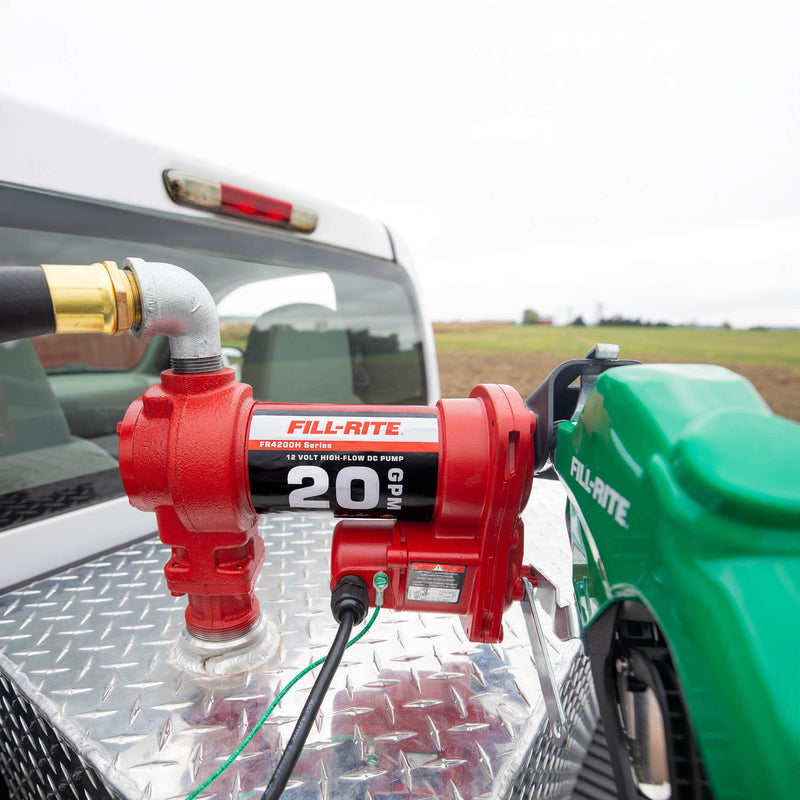 Fill-Rite FR4210HD 12V DC 20 GPM Fuel Transfer Pump with Nozzle, mounted on a diamond-plate transfer tank in a pickup bed