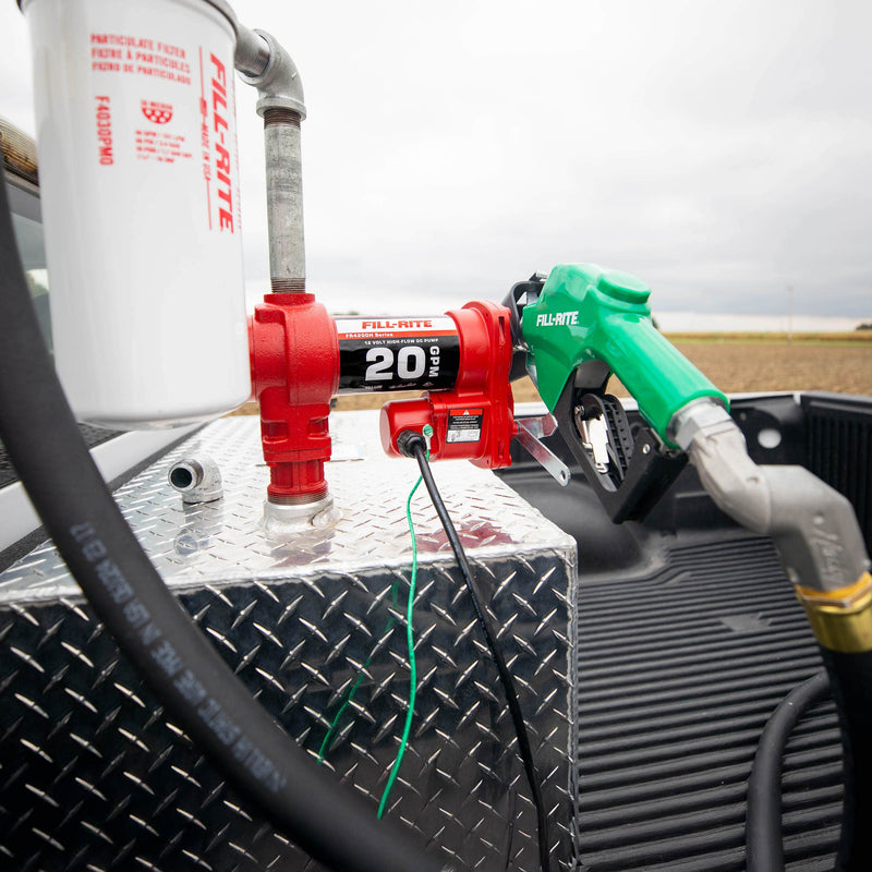 Fill-Rite FR4220HDSFQ 12V DC 20 GPM Fuel Transfer Pump with Nozzle, Filter, & Swivel, mounted on a diamond-plate transfer tank in a pickup bed