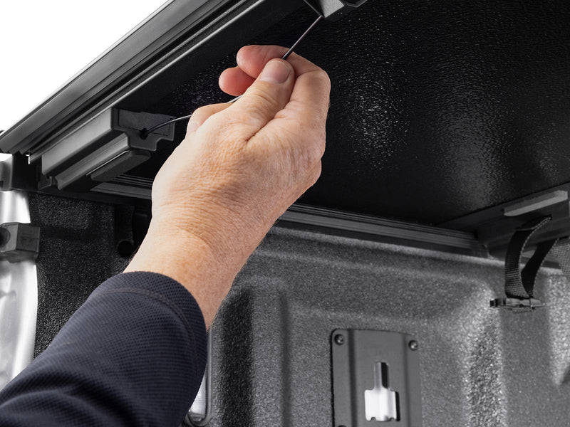 A hand pulling the Gator EFX release cable under a raised hard panel