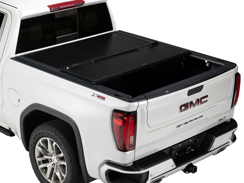 Gator EFX hard folding tonneau cover: A white full-size pickup with its hard folding cover partly folded toward the cab