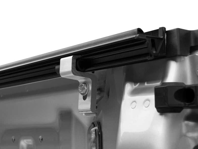Gator EFX hard folding tonneau cover: Close-up of a cover clamp mounted under the side rail inside a silver truck bed